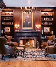 a living room filled with lots of furniture and a fire place in front of a painting