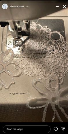 an embroidery machine with white lace on it