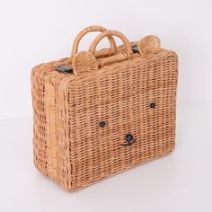 a brown wicker bag sitting on top of a white table