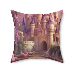 a pillow with a castle on the front and pink flowers on the back, along with a bridge leading to it