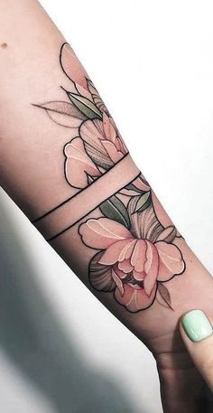 a woman's arm with flowers on it and the word love written in cursive writing