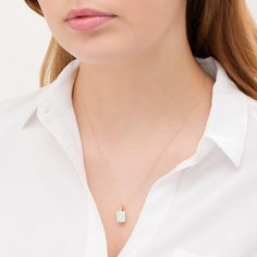 Chic and timeless, this divine fashion pendant is a delightful addition to her jewelry box. Created in warm 10K gold, this attractive look features a 10.0 x 8.0mm rectangle-shaped lab-created iridescent opal cabochon. Buffed to a brilliant luster, this pendant suspends from a sculpted bail along an 18.0-inch rope chain that secures with a spring-ring clasp. Elegant Yellow Gold Necklaces With Rectangular Stone, Elegant Oblong Gemstone Jewelry, Elegant White Rectangular Jewelry, Elegant Radiant Cut Birthstone Jewelry, Timeless Yellow Gold Jewelry With Rectangular Stone, Luxury Jewelry Gift With Oblong Shape, Timeless Rectangular Stone Jewelry For Gift, Timeless Rectangular Stone Jewelry Gift, Timeless Rectangular Gemstone Jewelry