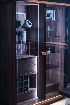 a wooden cabinet with glass doors and shelves