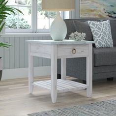 a living room scene with focus on the end table and couch in the foreground