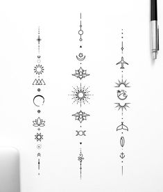 an assortment of tattoo designs on a white wall next to a pen and laptop computer