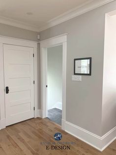 an empty room with white doors and hard wood flooring on the side of it