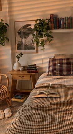 a bed with plaid sheets and pillows next to a book shelf filled with books on top of it