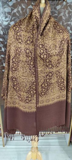 "🔷Vibrant Brown color 100% semi pashmina beautiful \"Jamavar\" Shawl/stole 80\"×28\" is fully fully embroidered by our talented and young artist. Jamavar means which is full covered/fill with embroidery. This shawl/shawl is embroidered by Golden color thread to make shawl/stole more attractive and beautiful.And the thread of this embroidery is silk thread. 🔷The Product is made of combination of wool and Pure Pashmina. 🔷The shawl/stole have beautiful handmade fringes too in the two end. 🔷This Beige Pashmina Shawl With Intricate Embroidery, Gold Traditional Pashmina Shawl, Luxury Brown Traditional Pashmina Shawl, Luxury Beige Embroidered Pashmina Shawl, Brown Embroidered Pashmina Shawl, Kashmir Embroidery, Ladies Shawl, Kashmir Shawl, Kashmiri Shawls