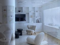 the interior of a living room with white furniture and shelves on either side of it