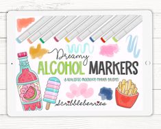 the alcohol marker book with markers and pens on it, next to some other items