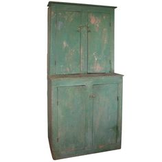 an old green cabinet with two doors