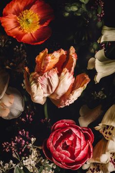 an arrangement of flowers on a black background