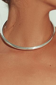 Made in Brazil, this tube choker’s sleek design is sculpted from sterling silver – simple enough for everyday and special enough for nights out and occasion. The perfect weight for solo wear or stacking, layer as desired for a modular effect. Jewelry Collection Handcrafted in Brazil Sterling Silver over Brass Thickness: 8.3mm Inner Diameter: 5" Opening: 3.25" Weight: 0.90 oz Waterproof Hypoallergenic Silver Tube Necklace, Silver Necklace Choker, Unique Silver Necklaces, Chocker Neckless, Silver Necklaces Layered, Silver Jewelry Stack, Silver Necklace Stack, Chain Necklace Outfit, Choker Design