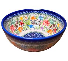 a blue and white bowl with colorful designs on it