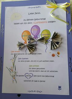 a brooch with balloons attached to it on top of a piece of white paper