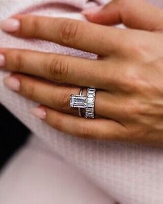 a woman's hand with two rings on it