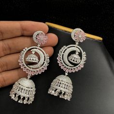 These Silver Polish American Diamond Long Chandbali Jhumka Earrings are perfect for a special occasion. With an intricately detailed crescent moon dangle and radiant American diamond, they shine as exquisitely as they look. Ideal for traditional Indian weddings, these earrings will make an iconic statement. Heavy Silver American Diamond Jhumkas, Silver Chandbali American Diamond Jhumkas, Silver Festive Dangle Jhumkas, Bollywood Silver American Diamond Jhumkas, Festive Heavy American Diamond Jhumkas, Silver Earrings Wedding, Crescent Moon Earrings, Traditional Indian Wedding, Cz Jewelry