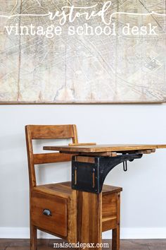 a wooden desk with a chair underneath it and the words vintage school desk above it