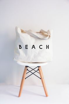 One word: Beach. The best place to relax, revitalize, and roll through the waves. Show your appreciation for sandy shores and salty tides with the Beach Tote! Measures 20"W x 15"H x 5"D100% Cotton Cotton Beach Bag, Bride Tote Bag, Wedding Tote Bag, Bride Tote, Aloha Beaches, Wedding Tote, Beach Tote Bags, Beach Tote, Large Bag