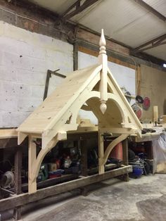 a wooden structure is being built in a workshop