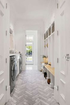 a laundry room with an open door leading to the washer and dryer area