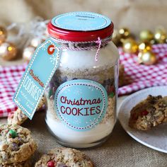 cookies in a glass jar next to christmas cookies