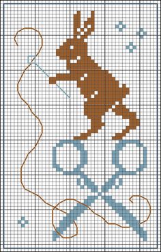 a cross stitch pattern with a rabbit holding a bow