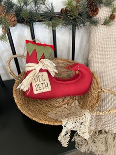 a pair of red shoes sitting on top of a wooden chair next to a christmas tree