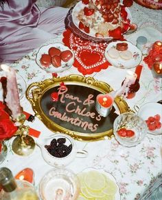 a table topped with lots of food and candles