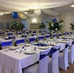 the tables are set with white and blue linens