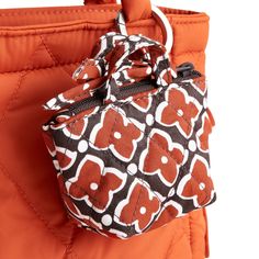 Add a touch of flair to your bag or backpack with our Original Tote Bag Charm. Designed to elevate your accessory game, this stylish charm features a tiny tote bag that adds a playful touch to any bag, making it the perfect accessory to express your unique sense of style. Vera Bradley Original Tote Bag Charm in Moorish Orange/Black Chic Small Bags With Removable Pouch, Chic Small Bag With Removable Pouch, Trendy Small Bags With Removable Pouch, Trendy Small Bag With Removable Pouch, Small Bags With Detachable Handle For Everyday Use, Small Bag With Detachable Handle For Everyday Use, Small Shoulder Bag With Detachable Strap, Small Everyday Bag With Detachable Handle, Small Shoulder Bag With Removable Pouch For Daily Use