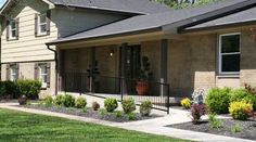 the front yard of a house with landscaping around it