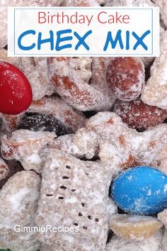 birthday cake chex mix with blue and red candies in the middle, surrounded by powdered sugar