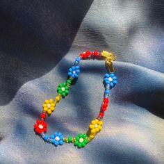 a colorful beaded bracelet on a blue fabric