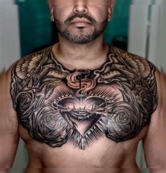 a man with tattoos on his chest and chest