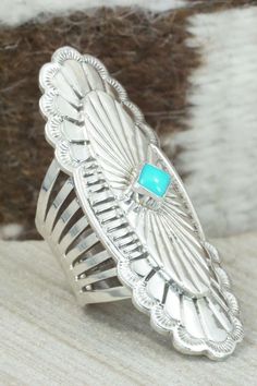 This vintage turquoise and sterling silver ring was made by Navajo silversmith Mike Smith. The back of the ring is signed RB and stamped sterling. Please note this is a pre-owned piece, with patina, in vintage condition.Size: 6.5Length: 2 1/4"Width: 3/4"Free shipping on all orders! We ship with USPS and always include tracking. All orders ship within a day of payment.Returns are accepted up to 30 days after you receive your order. Just send us a message. Our shop offers cash back or store credit Sterling Silver Turquoise Rings With Concho Detail, Western Sterling Silver Turquoise Concho Ring, Silver Turquoise Concho Ring In Sterling Silver, Bohemian Engraved Turquoise Ring In Sterling Silver, Handmade Silver Turquoise Ring In Western Style, Western Silver Turquoise Ring Stamped 925, Handmade Western Style Silver Turquoise Ring, Western Sterling Silver Turquoise Ring With Patina, Southwestern Stamped Turquoise Ring