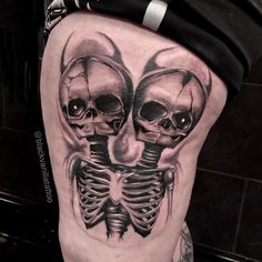 a man's thigh with two skulls on it