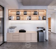 an office with white walls and wooden shelves filled with black and white items, including printer equipment