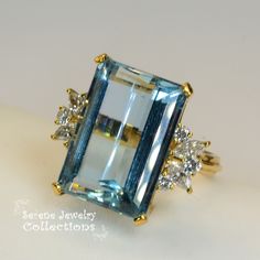 Thank you for coming in! Pretty large aquamarine 18k yellow gold Diamond vintage ring! Marquise and round diamonds are set into each side totaling 1 carats! Ring Size: 6.5 Total Weight: 11.1 grams Precious Metal: 18k yellow gold Precious stones: -Aquamarine Center Stone: 16.2 carats, 19.5mmx13.5mm -White Round Diamonds: 1ct, Marquise x4, Round x6 Hallmark: 18k Luxury Light Blue Rings For Anniversary, Elegant Aquamarine Diamond Ring For Anniversary, Luxury Light Blue Topaz Ring For Anniversary, Luxury Light Blue Topaz Ring For Wedding, Gold Aquamarine Diamond Ring For Anniversary, Gold Diamond Ring With Aquamarine, Yellow Gold Aquamarine Rings For Anniversary, Luxury Light Blue Topaz Wedding Ring, Gold Aquamarine Diamond Ring