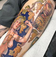 a man with a tattoo on his arm is sitting in front of a mirror and grapes