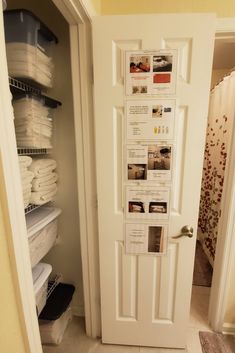 a white door is open to show the inside of a closet filled with folded towels