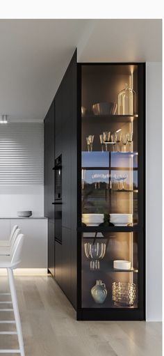 an open cabinet in the middle of a kitchen with white chairs and counter tops on each side