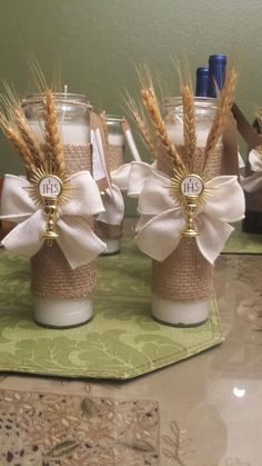 three mason jars decorated with burlocks and twine are sitting on a table