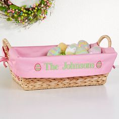 a pink basket filled with eggs on top of a table