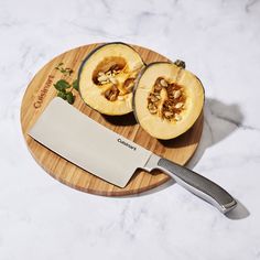 a cutting board with a knife on top of it next to some cut up fruit