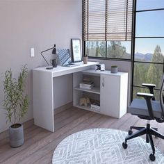 an office with a desk, chair and computer monitor on top of the desk in front of a window