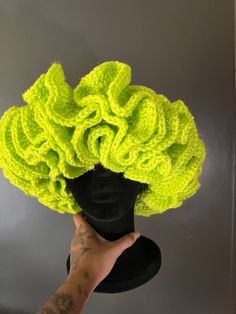 a wig made to look like a flower is being held up