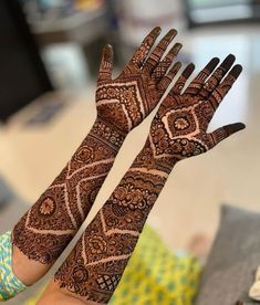 two hands with henna designs on them