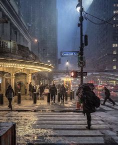 people crossing the street on a rainy day in new york city, ny at night