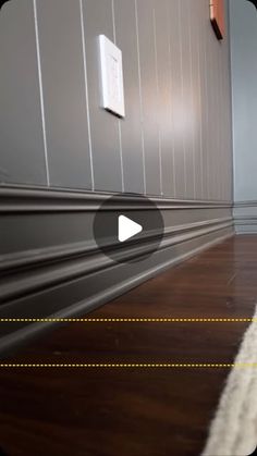 an image of a room with wood floors and white trim on the walls that are striped in yellow